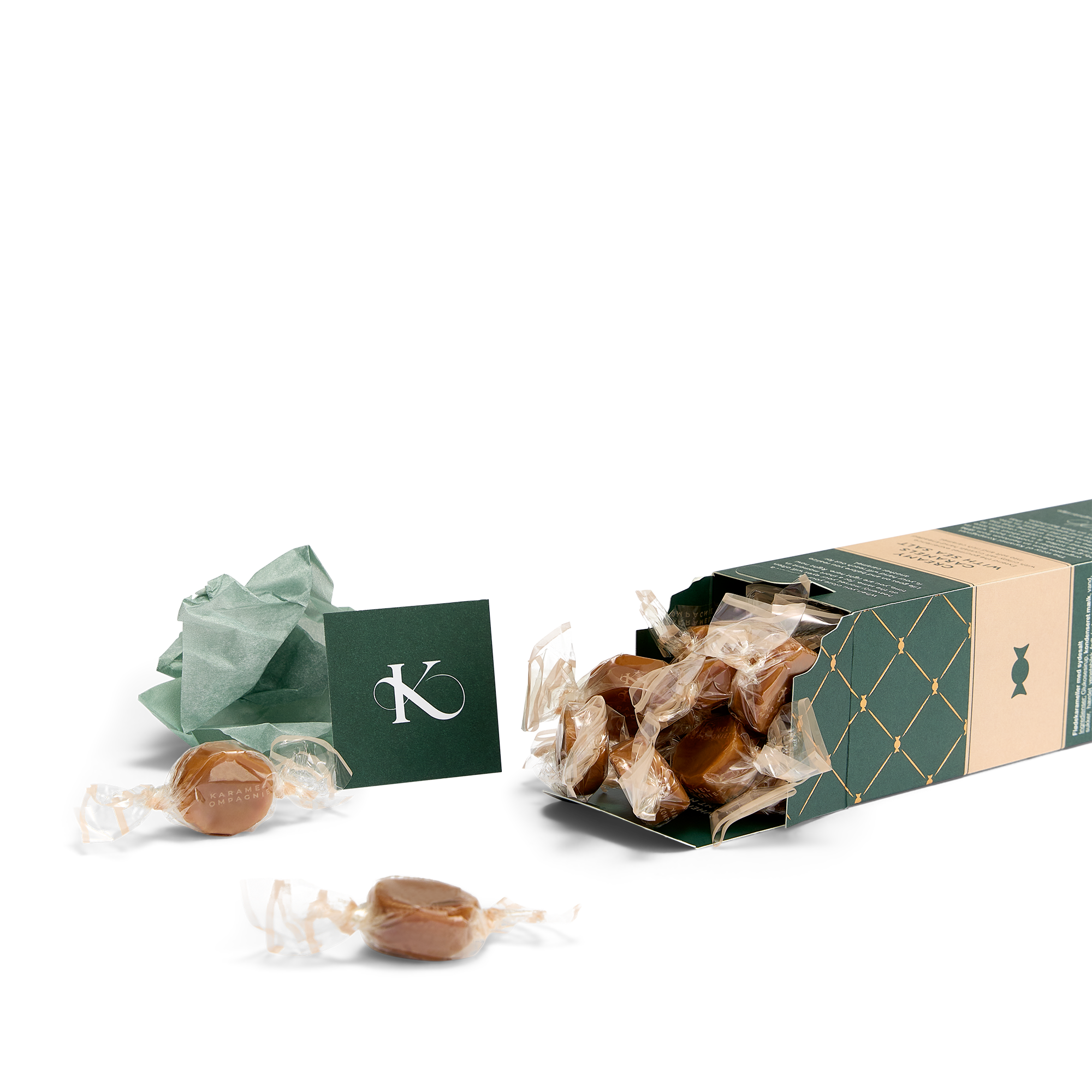Saltkarameller i æske, der ligger ned med karameller der flyder ud