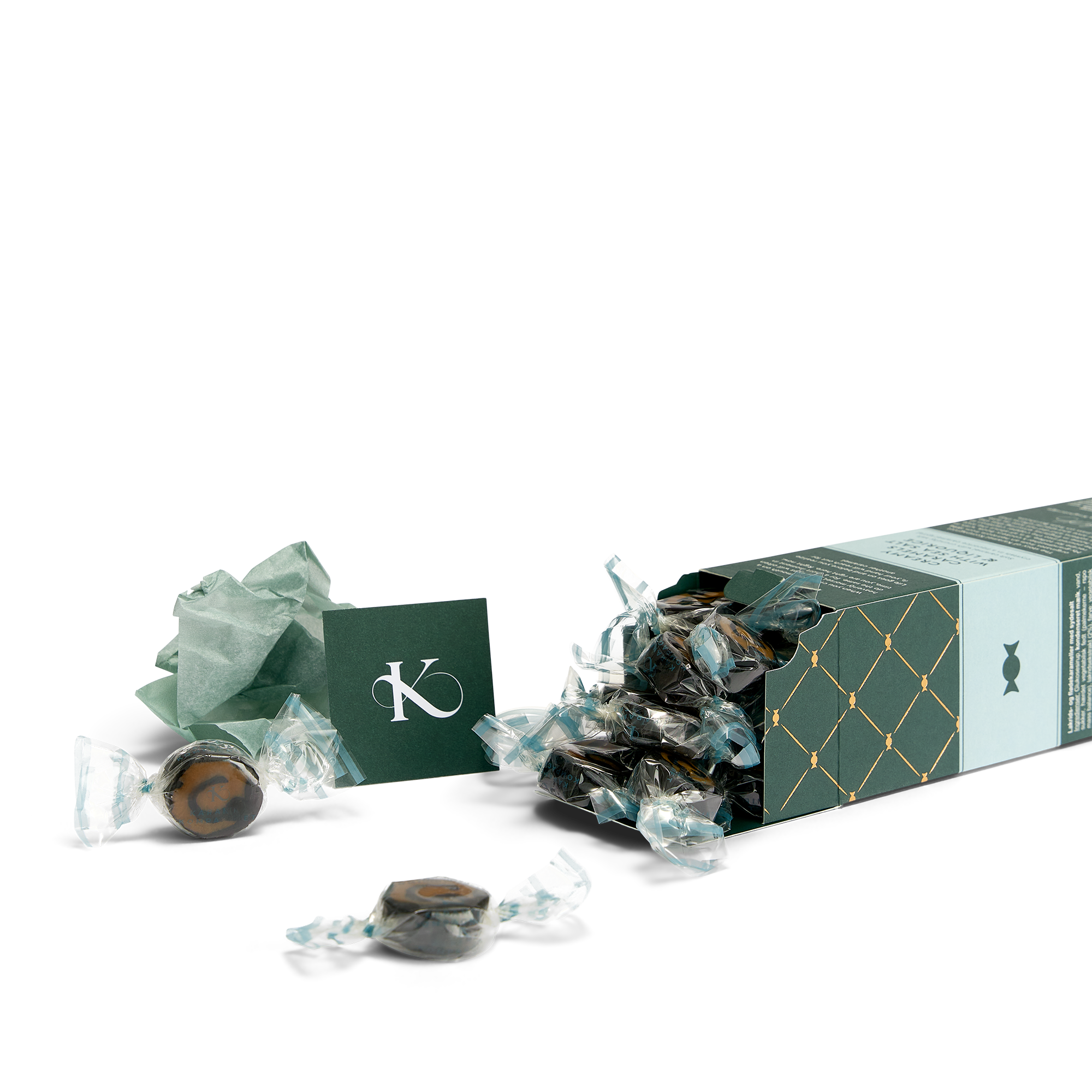 Lakrids- og Flødekarameller med Sydesalt i æske, der ligger ned med karameller der flyder ud