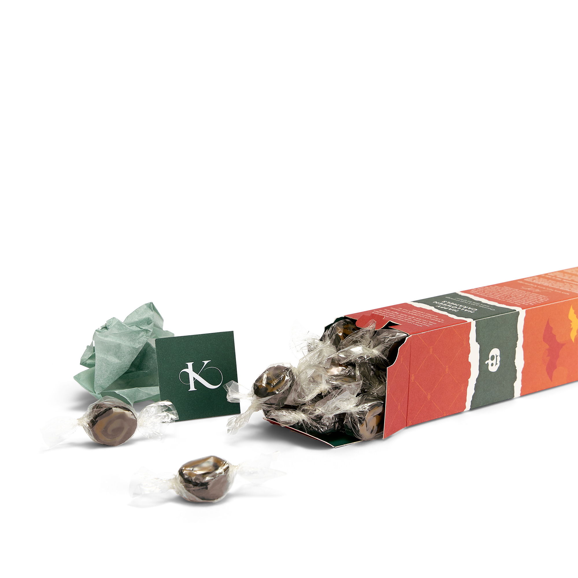 Chokolade- og appelsinkarameller - Happy Halloween H æske der ligger ned med karameller flydende ud